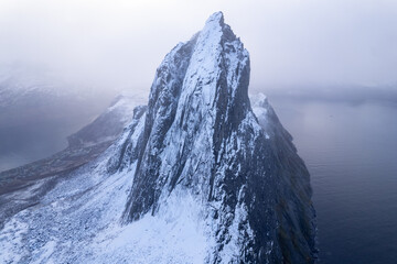 Aerial drone photo of snowy mountain hike up Segla in Senja, Norway.  Snowcapped mountains in the...