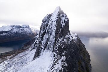 Aerial drone photo of snowy mountain hike up Segla in Senja, Norway.  Snowcapped mountains in the...