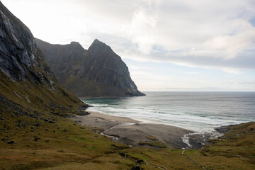 Kvalvika Beach at sunset in Lofoten, Norway in the Arctic Circle.  One of Norway's most beautiful beaches. with tower cliffs and large waves.