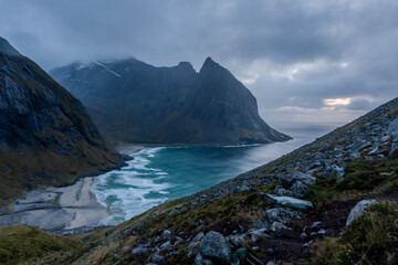 Kvalvika Beach at sunset in Lofoten, Norway in the Arctic Circle.  One of Norway's most beautiful beaches. with tower cliffs and large waves.