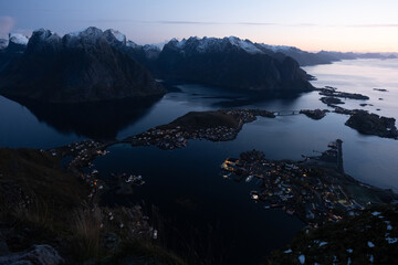 Views from top of Reinebringen mountain hike in Lofoten, Norway.  Snow covered mountains captured...