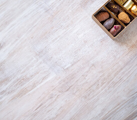 Top-View of Luxury Chocolate Box with Multiple Varieties in Stunning Golden Hues. Elegant Packaging with Copy Space. Perfect for Celebrations, Gifts, and Indulgent Occasions