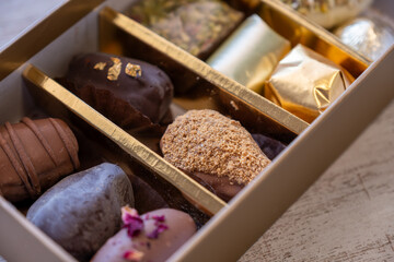 Top-View of Luxury Chocolate Box with Multiple Varieties in Stunning Golden Hues. Elegant Packaging...