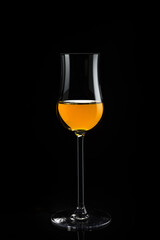 Glass of whiskey on a black background. 