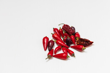 Small hot chili peppers on a white background.