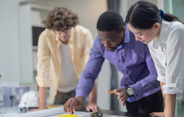 Architects plan low-carbon construction, analyzing blueprint, layout, calculating precise structure