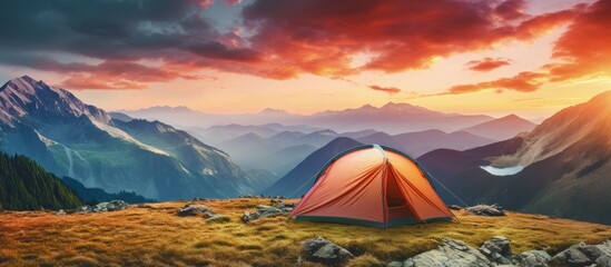 Colorful evening sky seen from a mountain campsite where travelers enjoy an adventurous vacation copy space image