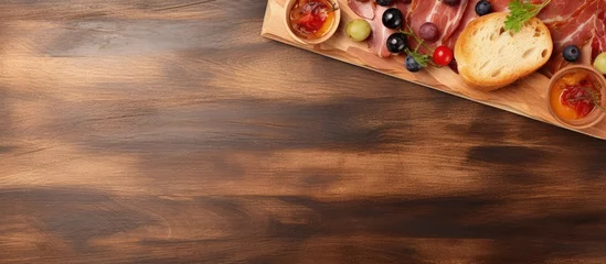 Tuinposter Close up top view of a bacon and olive sandwich on a cutting board no people copy space image © vxnaghiyev