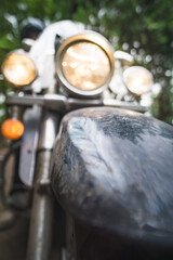 Cruiser motorcycle front with glowing headlights in close-up for background