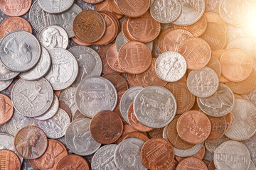 American coins and US dollars on a wooden table