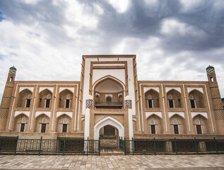 Facade of the historical monument Amir Tura Madrasah with facing in the ancient city of Khiva in...