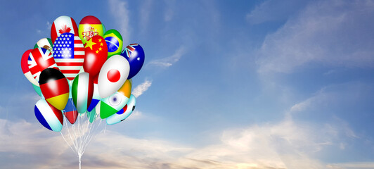 Colorful flag of different countries on ballon against blue sky with white cloud