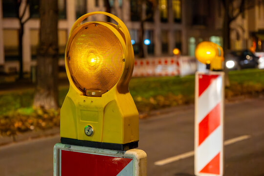 Construction site on a street in the city at night with warning lights
