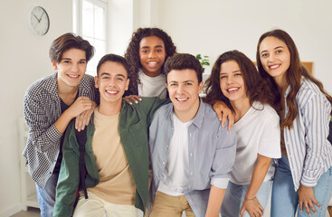 Portrait of a group of happy smiling diverse high school students and classmates in casual clothes...