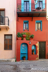 Fototapeta na wymiar Room Honeymoon the red guest house at Chania, paved alley in Old Town, Crete island Greece. Vertical