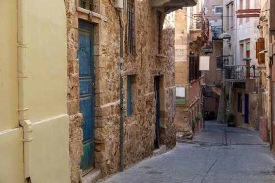 Narrow alley, traditional stonewall building, summer day. Chania Old Town, Crete island, Greece.