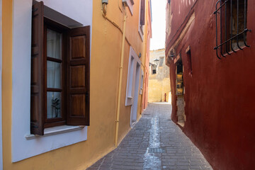 Traditional narrow paved alley between multicolor building. Chania Old Town, Crete island, Greece.