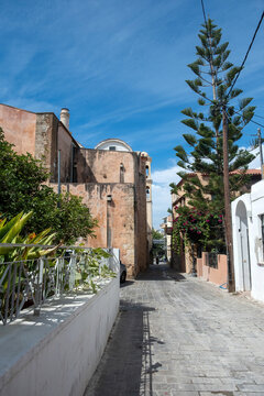 Crete island, Chania Old Town, Greece. St. Nicholas Church, araucaria heterophylla, alley. Vertical