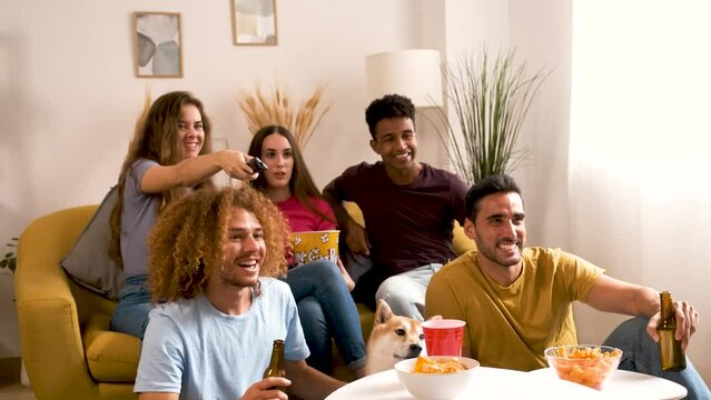 Friends watching movies together at shared student flat.