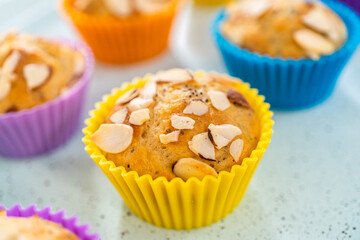 Lemon poppy seed muffins garnished with almond slivers