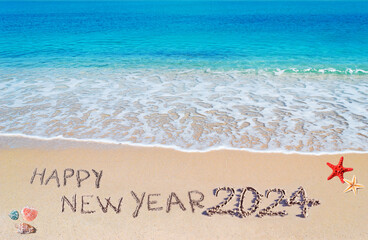happy new year 2024 written on the shore