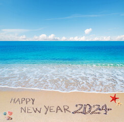 Fototapeta na wymiar happy new year 2024 written in the sand