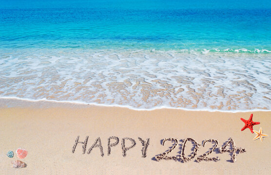 Happy 2024 written on the sand