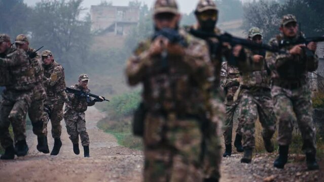 Soldiers Run and Suddenly Flee to Cover to the Side, Ruined Houses Behind Them