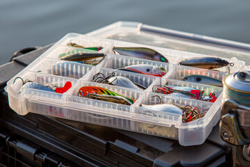 A large fisherman's tackle box fully stocked with lures and gear for fishing.fishing lures and...