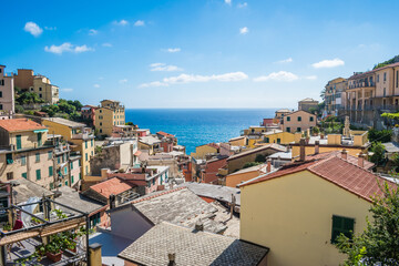 Architecture with colorful houses and blue Mediterranean sea in the background, Riomaggiore ITALY