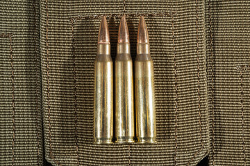 3 rounds of 5.56x45mm caliber close-up.