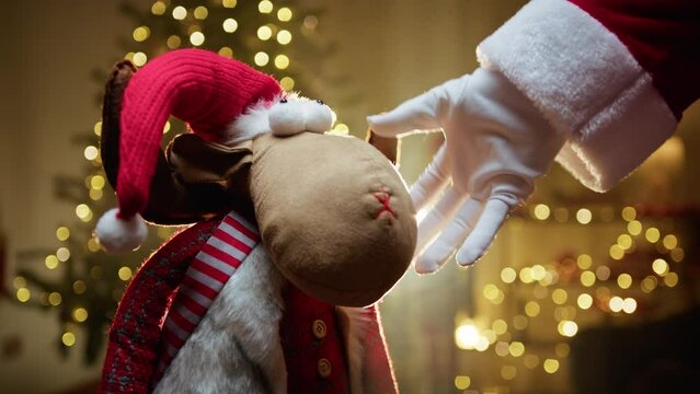 Santa Claus caresses Christmas reindeer Toy