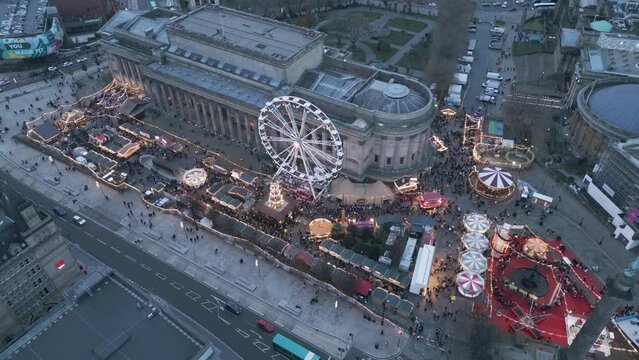 Aerial slow approach view of Liverpool Christmas Market round St George's Hall, Merseyside, England