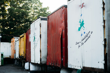 Trailers of different colors parked from a truck on an industrial estate, concept of road freight...