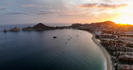 Beachfront Dawn Aerial Splendor of Cabo San Lucas Sunrise From Above Water Looking Towards the Harbor