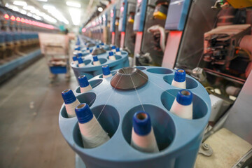 The spinning worker is working nervously on the spinning production line in a spinning factory