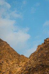 Fujairah mountains, extension of Omani Al Hajar mountain range. Cloudy winter day on empty street. High quality photo