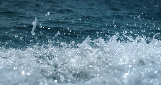 Super slow motion of water surface on light blue background. Filmed on high speed cinema camera at 1000 fps.