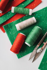 Composition with threads and sewing accessories on white background