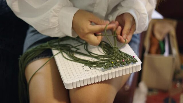 Women hands darning woollen yarns in Thailand