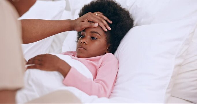 Mother, child and hands on forehead in bed, monitor wellness in family home for cold or flu. Black woman, daughter and check temperature for illness with worry, concern and care for sick kid in house