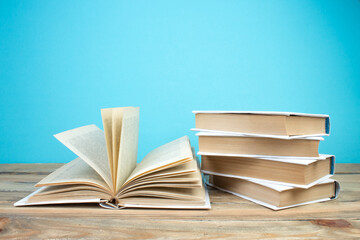 open book, books on the blue background. Back to school. Education. Copy space for text.
