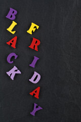 BLACK FRIDAY word on black board background composed from colorful abc alphabet block wooden letters, copy space for ad text. Learning english concept.