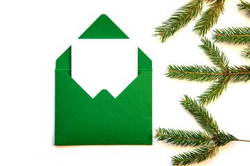 Fototapeta premium Creative layout made from a Christmas tree branch and a handmade envelope. Place for text. Christmas , holidays details, decorating, gifts, wrapping, new year atmosphere.