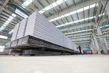 Workers are working intensively on the production line of new building materials - lightweight...