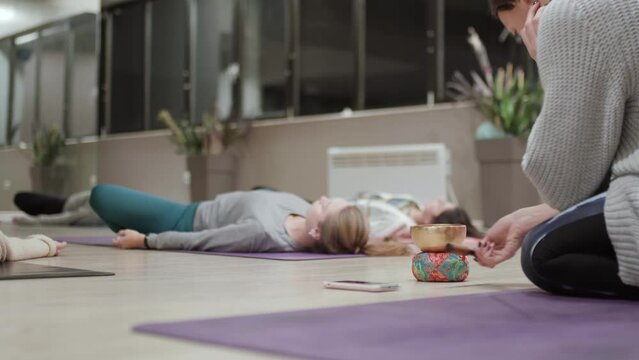 Yoga class having meditation session with gong instrument.