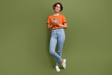 Full size photo of intelligent woman wear stylish t-shirt in glasses hold smartphone write email...