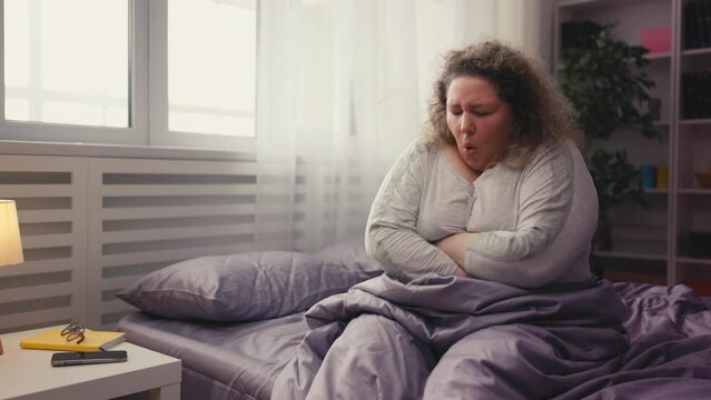 Overweight woman suffering sharp stomach ache, painful cramp, health problem