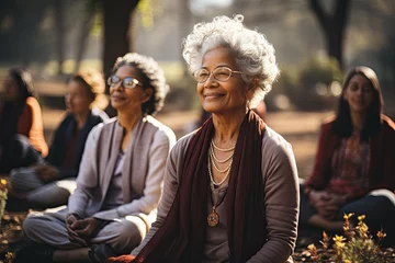 Fototapeten Group of elderly women doing yoga in the park © nnattalli