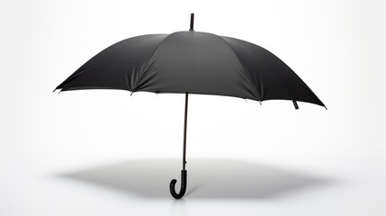 A sleek black umbrella, closed and resting, its curve and handle emphasizing its elegance against a pristine white backdrop.